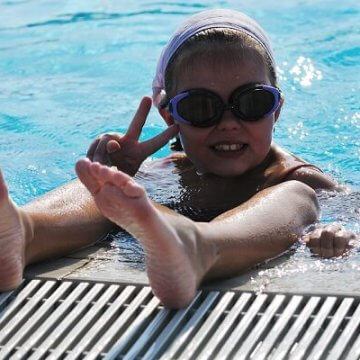 Child having fun in pool on staycation