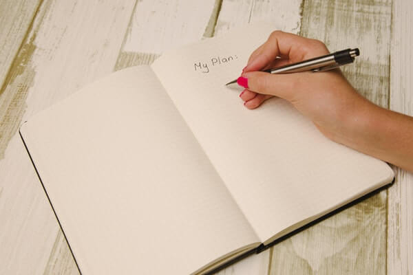 Hand with pen on budget