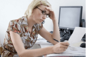 Stressed woman staring at budget