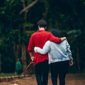 Man and woman walking dog. Affordable date ideas
