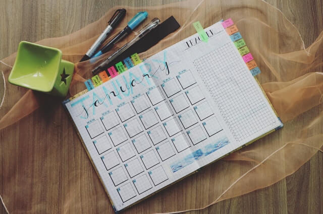 Photo of planner and pens. Tracking irregular bills