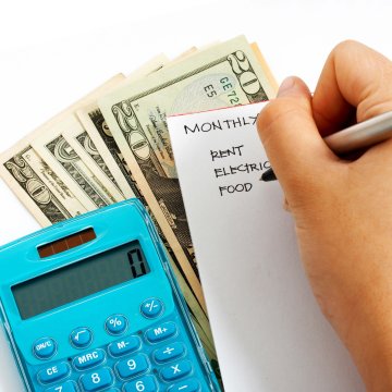 Cash, calculator and written budget.