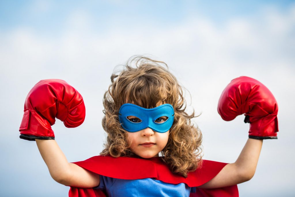 Curly haired super hero girl with boxing gloves