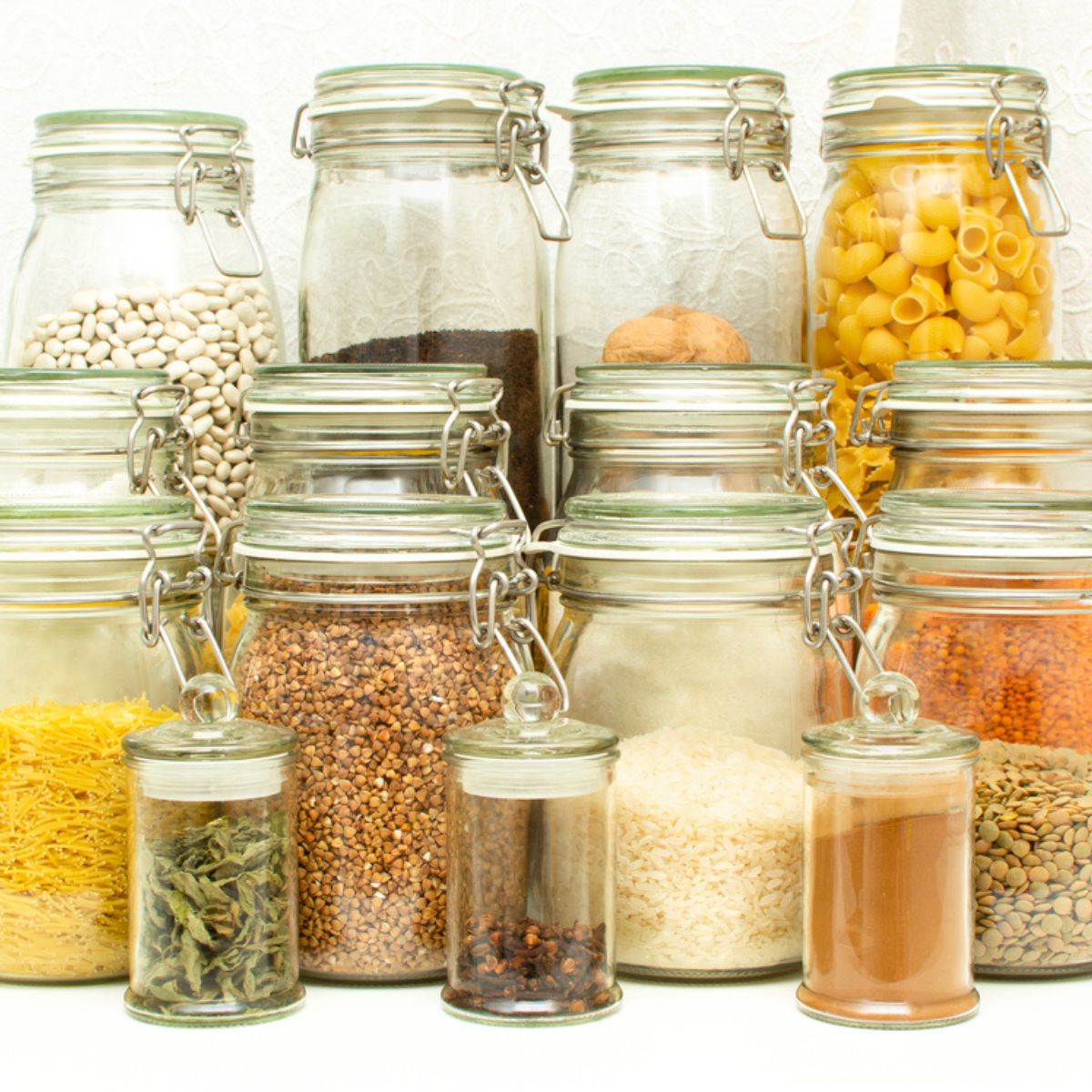 Jars of pantry staple items ideal for small budgets. Beans, pasta, spices, rice